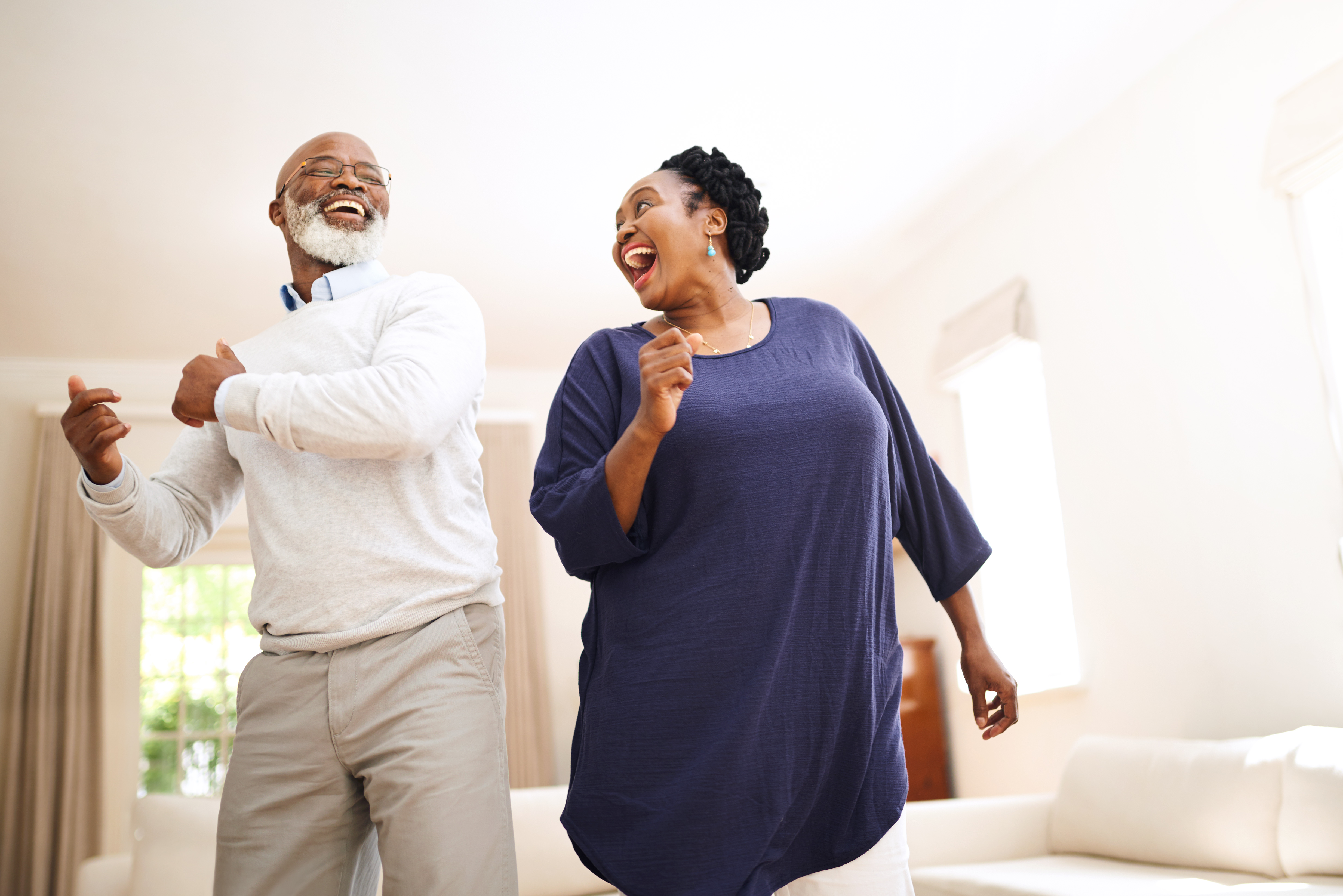 Lifestyle_Stock_Middleaged_Couple_Black_Laughing_Livingroom.jpg