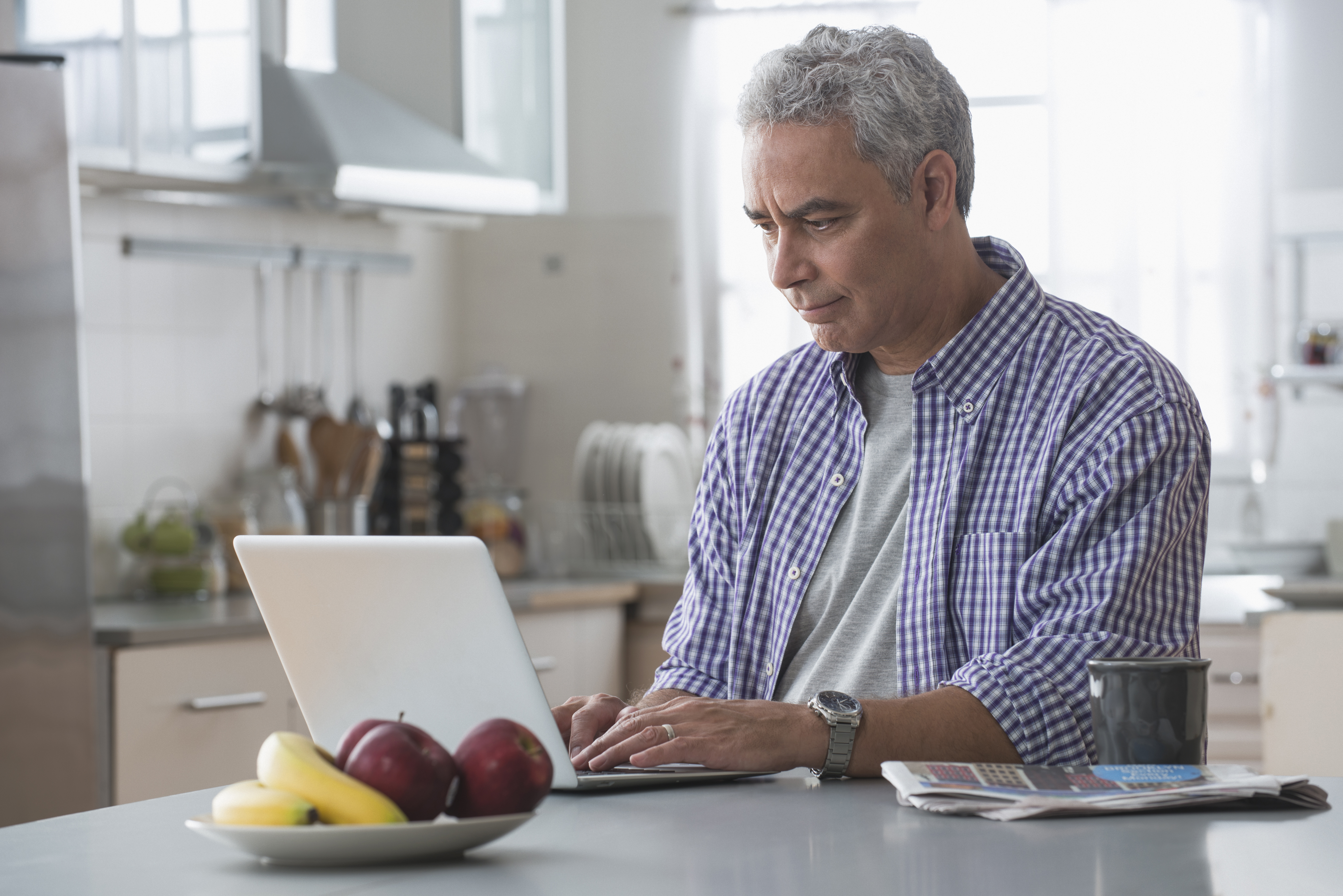 GettyImages-565975249_WhiteManKitchenComputer_highres.jpg